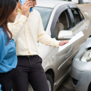 Two Drivers talking with insurance for car accident