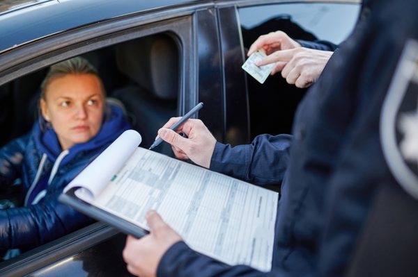 police checking a female driver's license for dwi